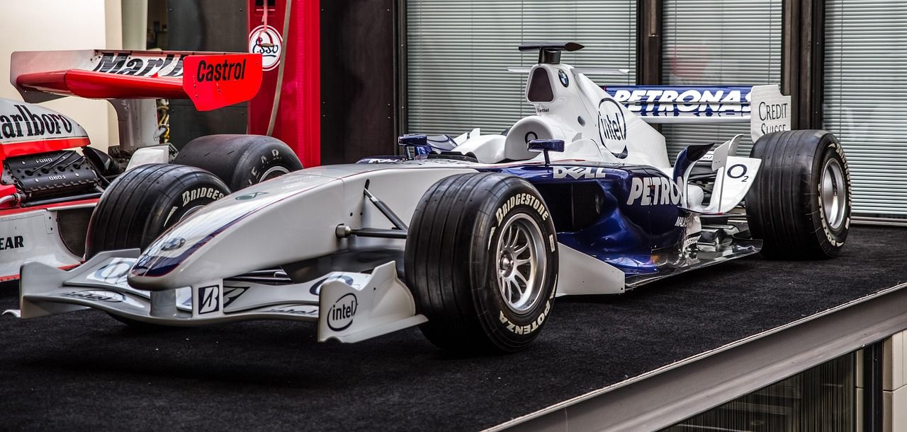 Formula 1 car racing at speed in wet conditions