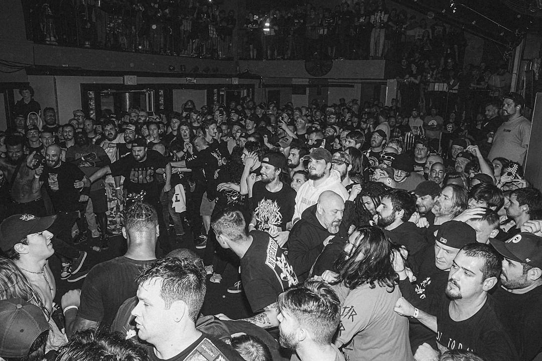 Wide-angle view of a large indoor arena crowd at a Premier League Darts event