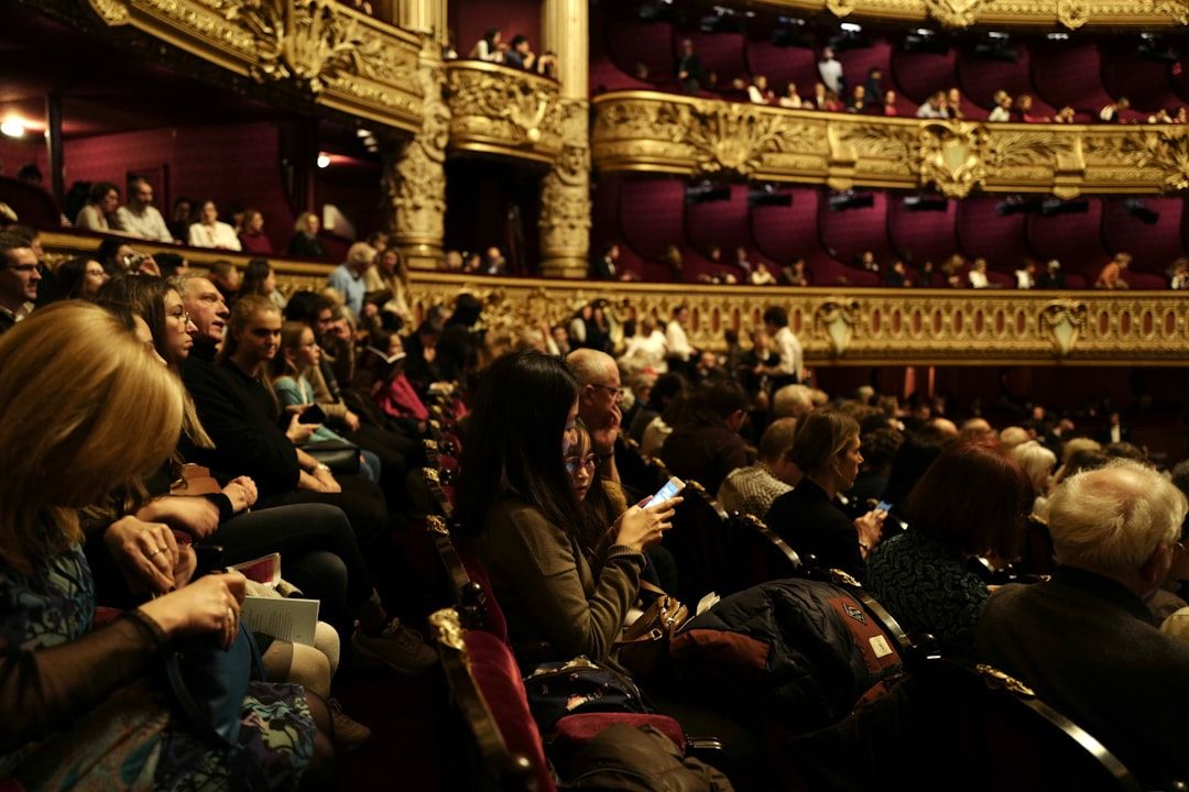 Theatre audience in red seats during an intimate performance