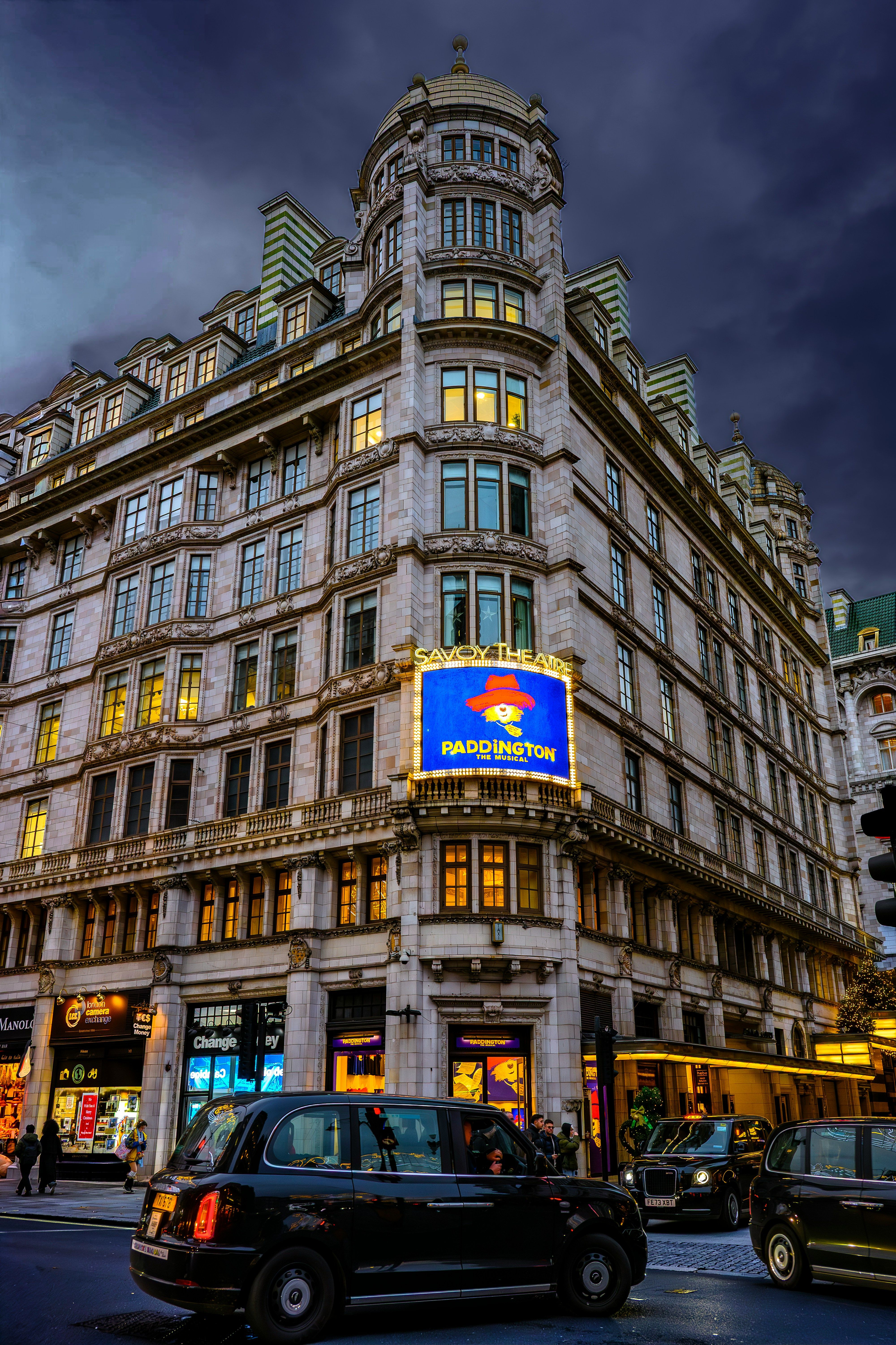 Historic London building at dusk with a black taxi