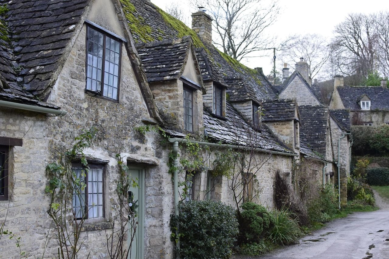 Stone cottages on a high-street in a Cotswolds market town