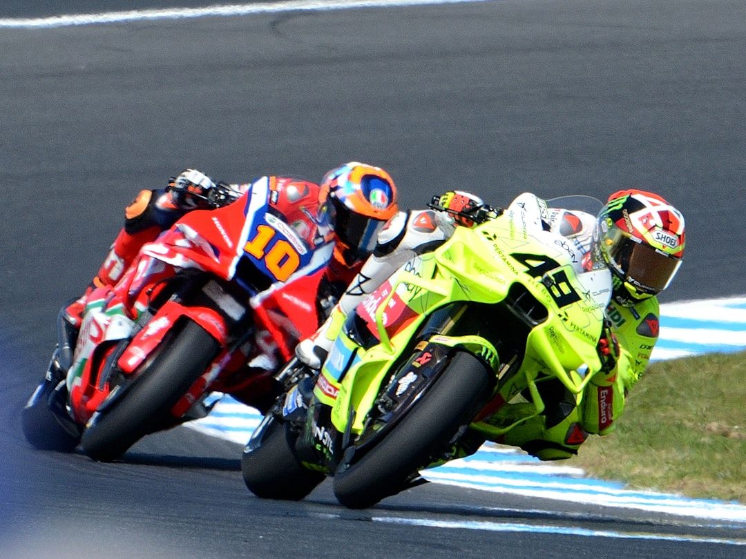 MotoGP riders racing in a tight pack on circuit