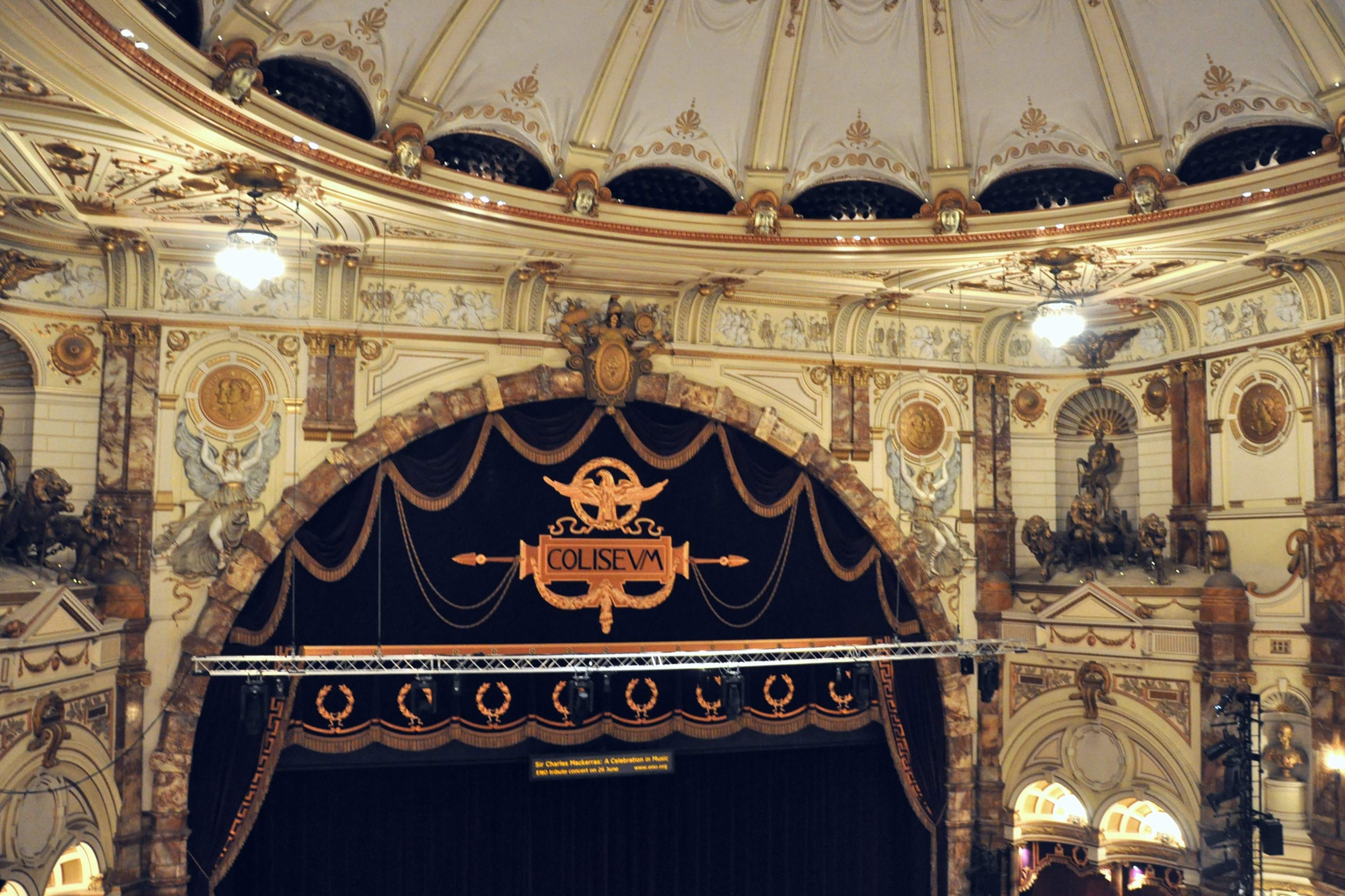 The London Coliseum auditorium from the dress circle: house curtain, boxes and gilded plasterwork