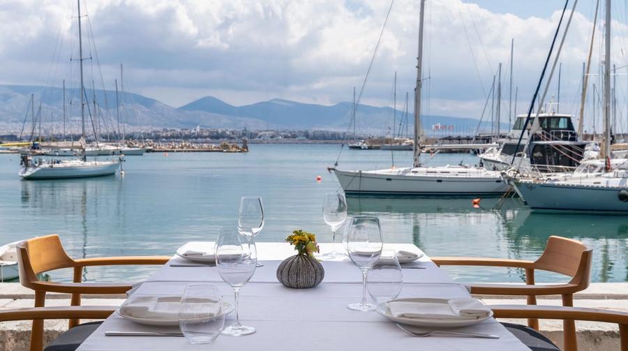 The terrace of Papaioannou seafood restaurant overlooking the marina at Mikrolimano in Piraeus, boats and the sea in the background