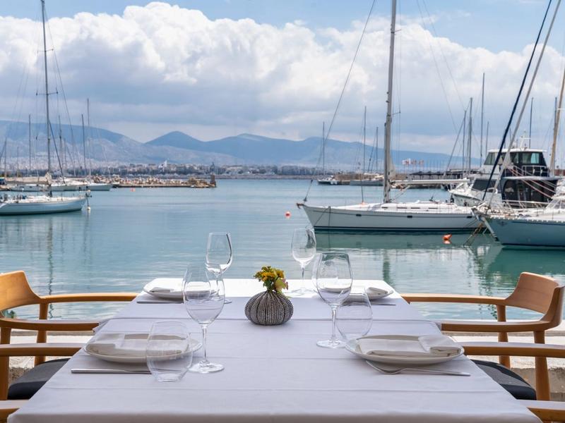 The terrace of Papaioannou seafood restaurant overlooking the marina at Mikrolimano in Piraeus, boats and the sea in the background