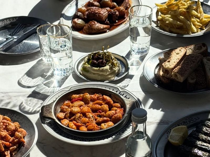 The warm, open-kitchen interior of Taverna Ermou by Ergon in Athens — raw materials, coastal flavours and a relaxed neighbourhood feel