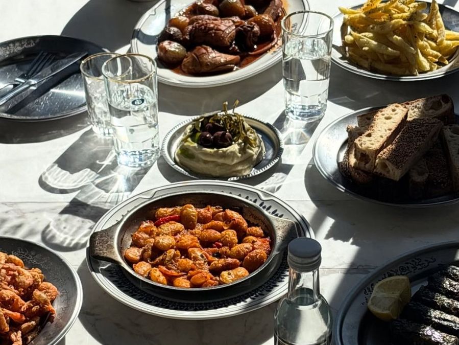 The warm, open-kitchen interior of Taverna Ermou by Ergon in Athens — raw materials, coastal flavours and a relaxed neighbourhood feel