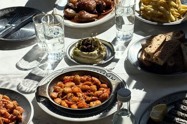 The warm, open-kitchen interior of Taverna Ermou by Ergon in Athens — raw materials, coastal flavours and a relaxed neighbourhood feel
