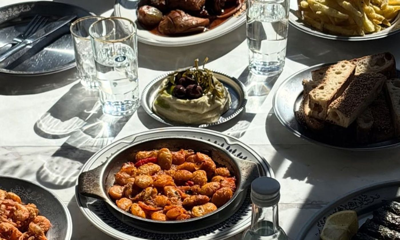 The warm, open-kitchen interior of Taverna Ermou by Ergon in Athens — raw materials, coastal flavours and a relaxed neighbourhood feel