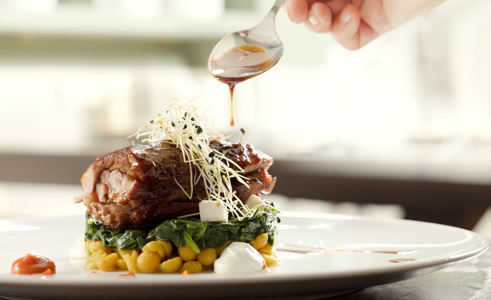 The intimate dining room of Mani Mani restaurant in Athens — warm light, neoclassical details and seasonal dishes from Lakonian Mani on the table