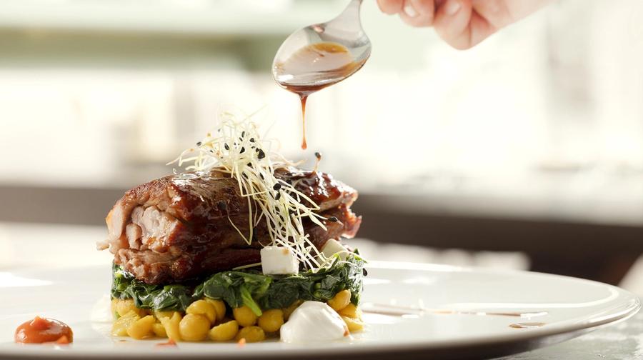 The intimate dining room of Mani Mani restaurant in Athens — warm light, neoclassical details and seasonal dishes from Lakonian Mani on the table