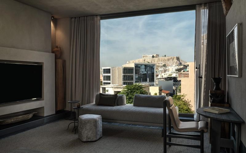 Interior of Monastik Living in Mets, Athens — an eleven-suite boutique hotel with glass walls, natural materials and views toward the Acropolis