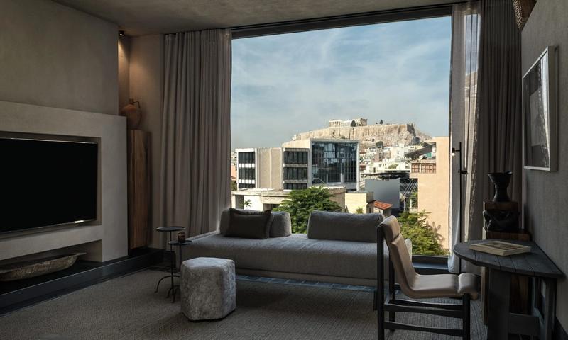Interior of Monastik Living in Mets, Athens — an eleven-suite boutique hotel with glass walls, natural materials and views toward the Acropolis