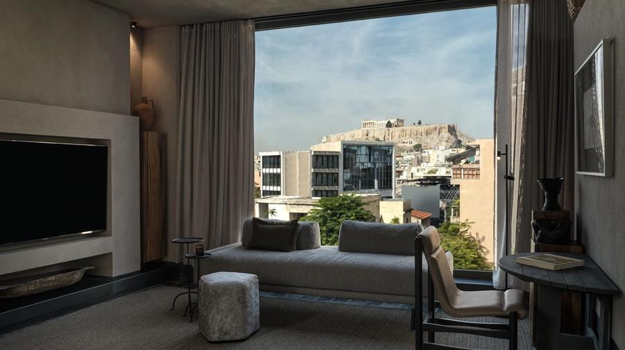 Interior of Monastik Living in Mets, Athens — an eleven-suite boutique hotel with glass walls, natural materials and views toward the Acropolis