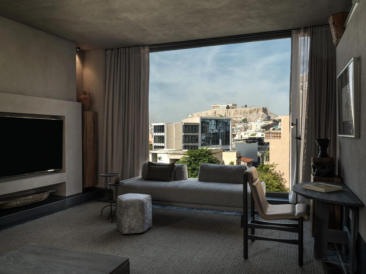 Interior of Monastik Living in Mets, Athens — an eleven-suite boutique hotel with glass walls, natural materials and views toward the Acropolis