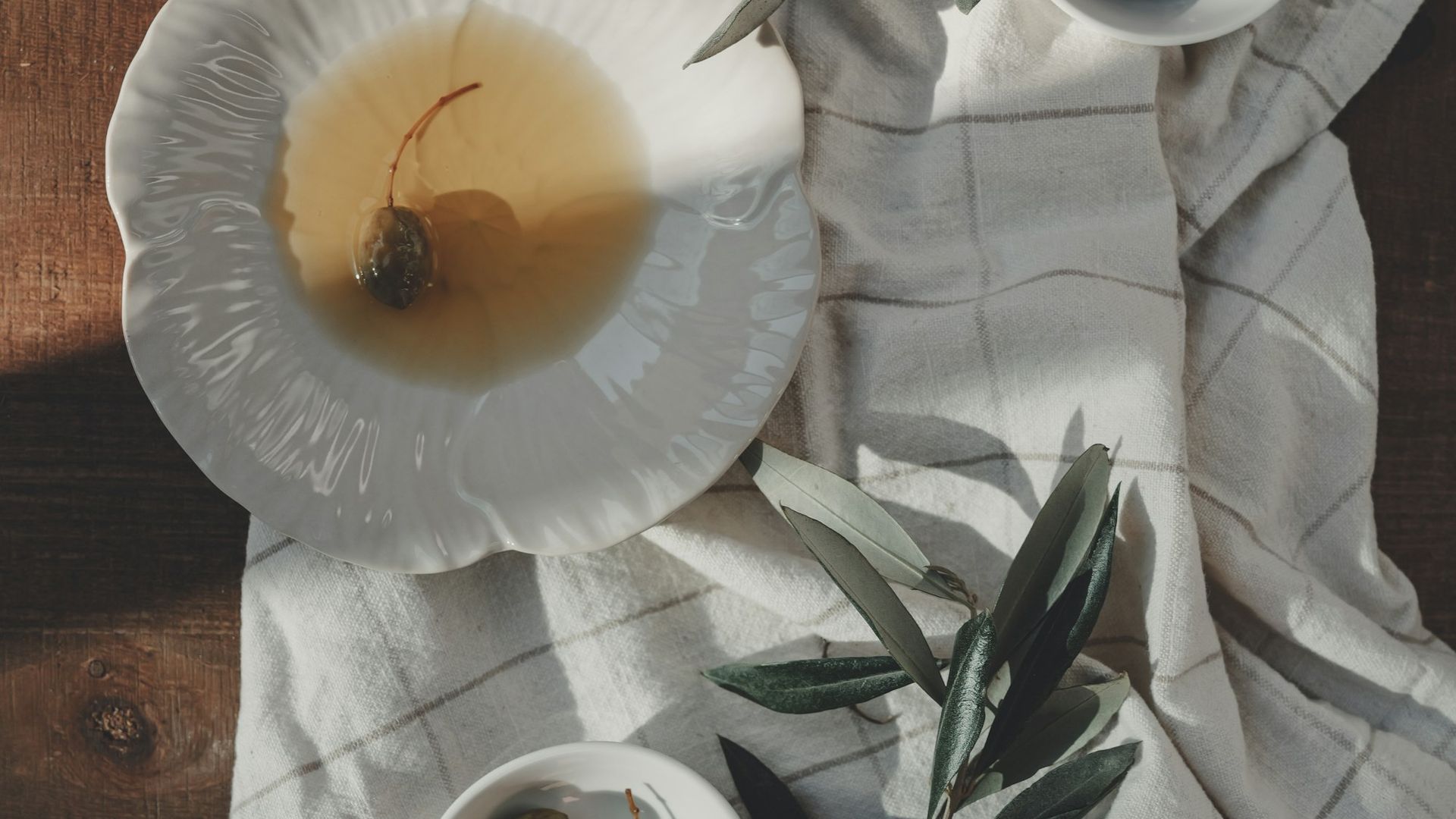Olives and olive oil still life, rustic Mediterranean setting
