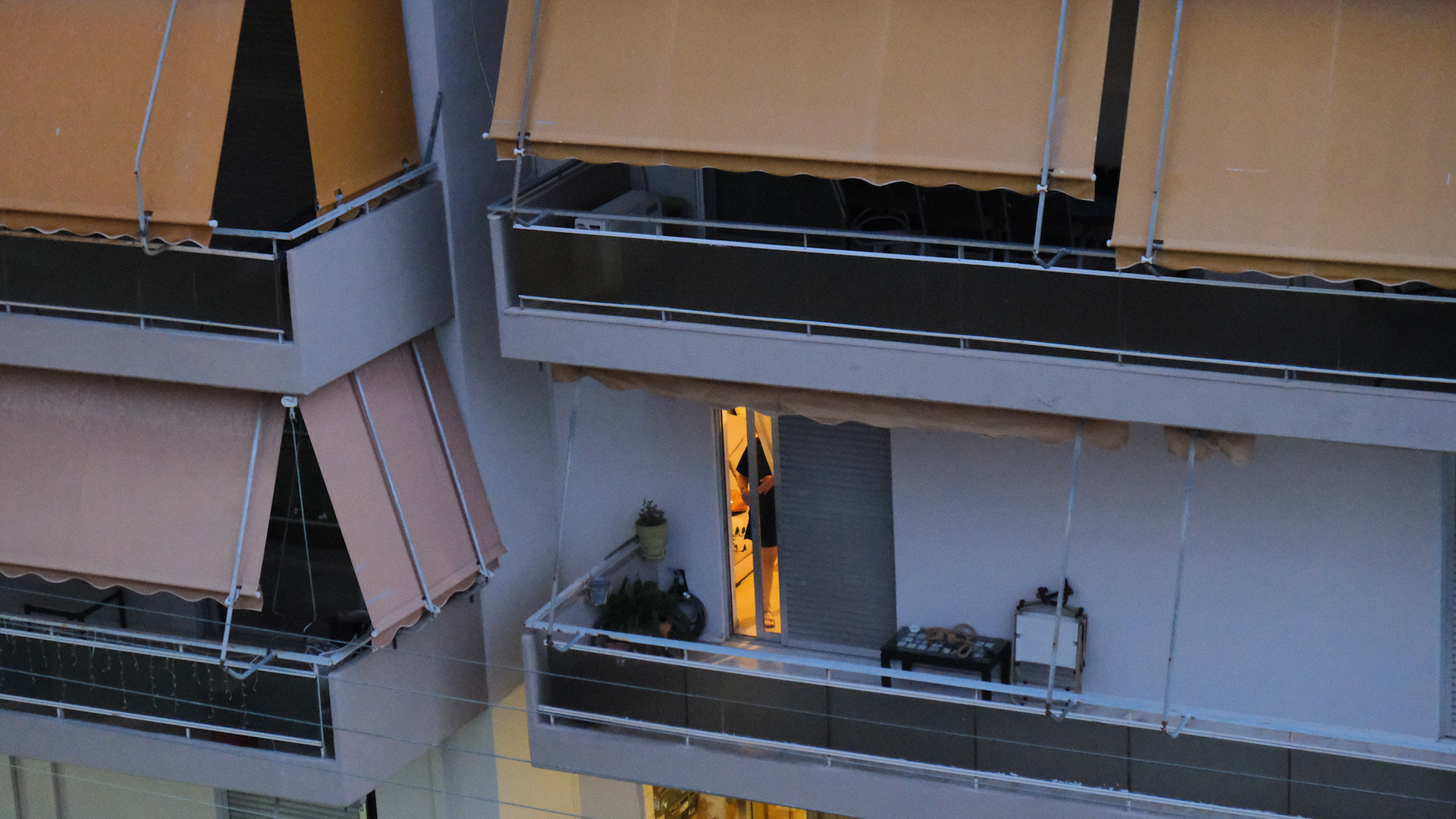 Athens polykatoikia balconies with orange awnings