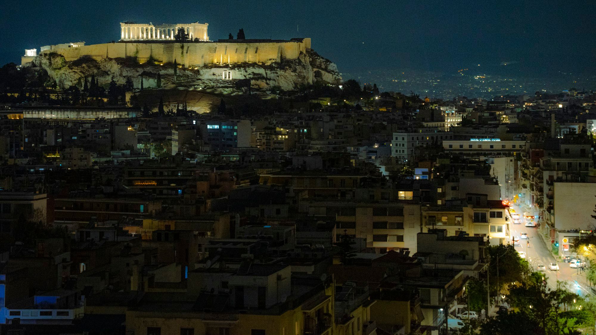Acropolis illuminated at night, Athens city below