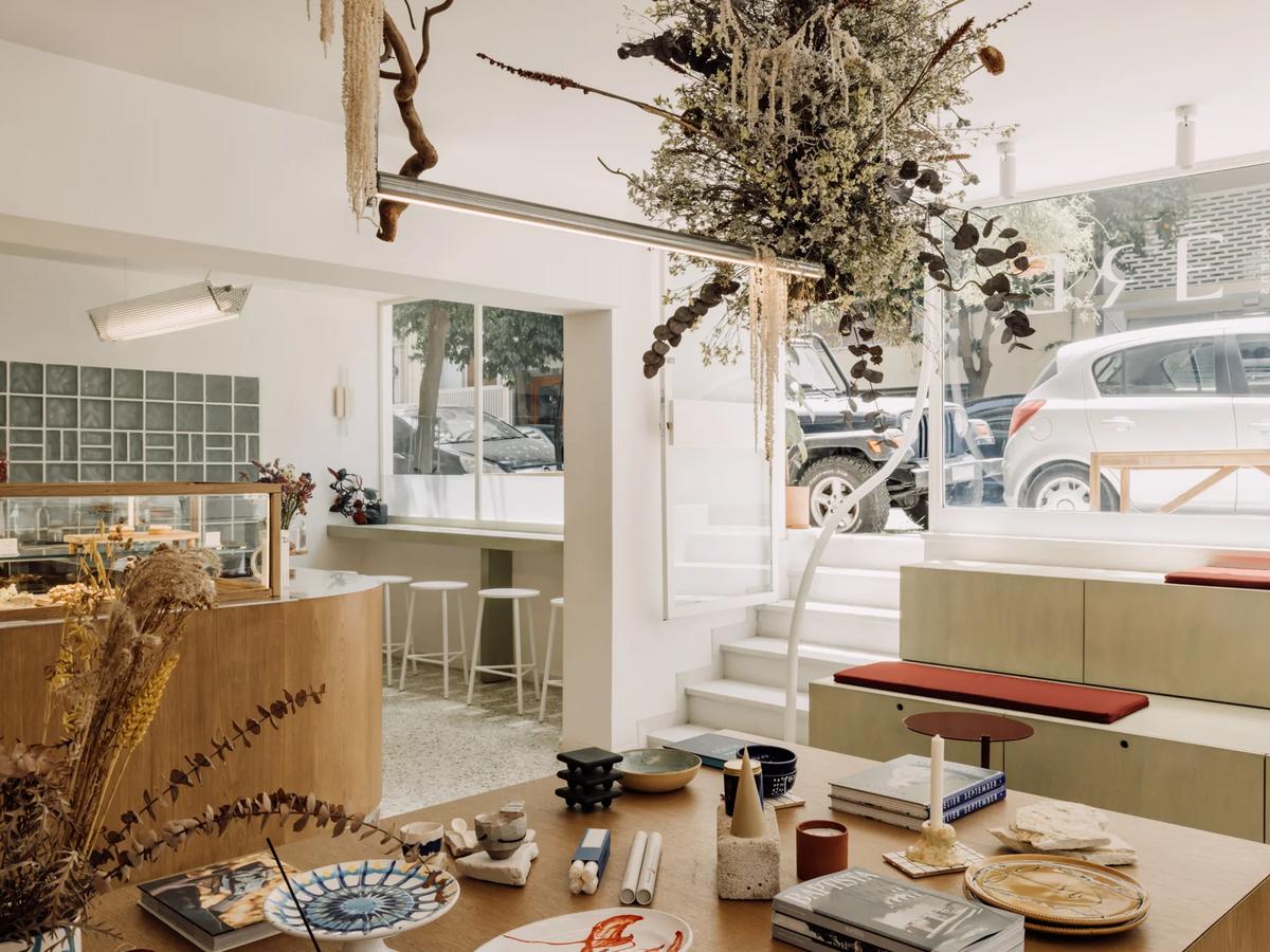 The interior of ERE Athens concept store and café in Koukaki — curated homeware, apothecary products and artisan goods on warm wooden shelves