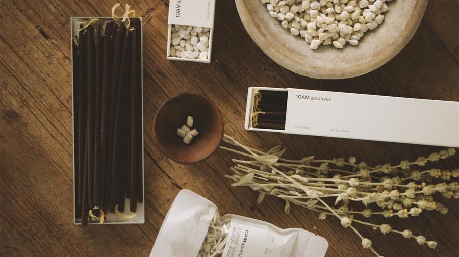 The curated interior of 10AM Apotheke in Kolonaki, Athens — natural beauty and lifestyle products arranged on warm wooden shelves