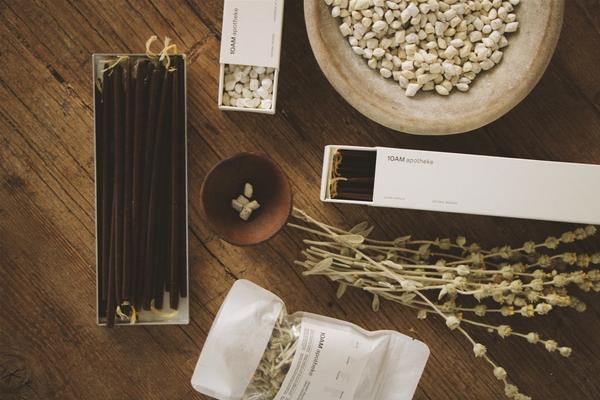 The curated interior of 10AM Apotheke in Kolonaki, Athens — natural beauty and lifestyle products arranged on warm wooden shelves