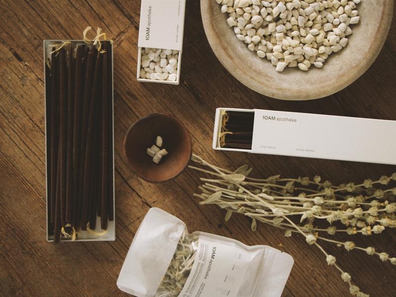 The curated interior of 10AM Apotheke in Kolonaki, Athens — natural beauty and lifestyle products arranged on warm wooden shelves