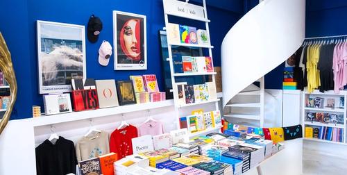 Hyper Hypo interior — Klein blue walls and curated book displays