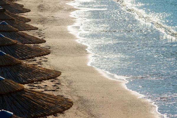 Akti Vouliagmeni Beach on the Athens Riviera — a sheltered bay at the foot of limestone cliffs with calm turquoise water