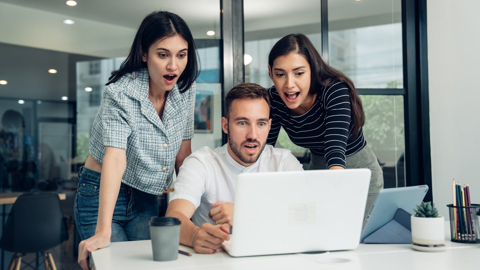 Team reviewing their website on a laptop in an office