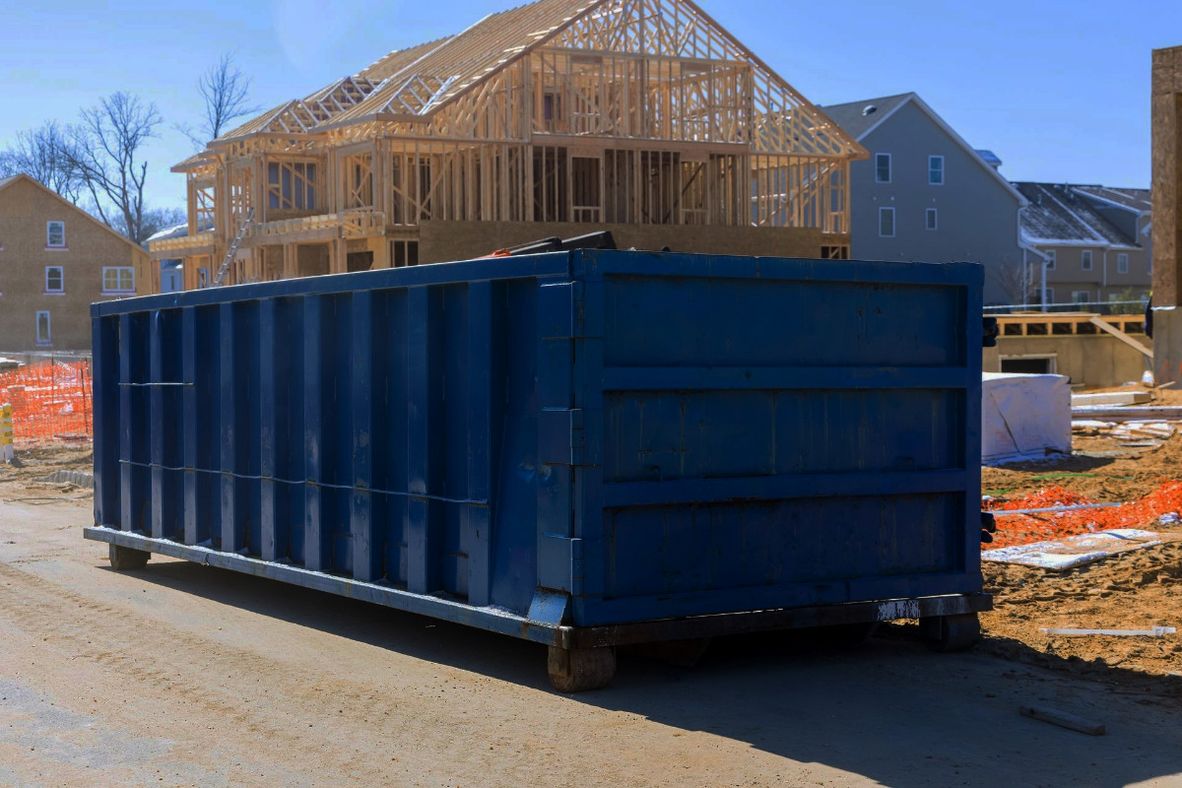 Construction dumpsters staged at a job site for a renovation or cleanout project