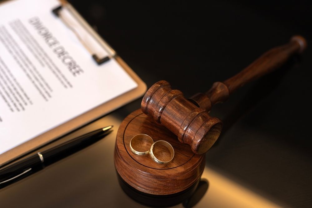 Gavel with wedding rings and divorce documents representing protection of business assets during an Illinois divorce