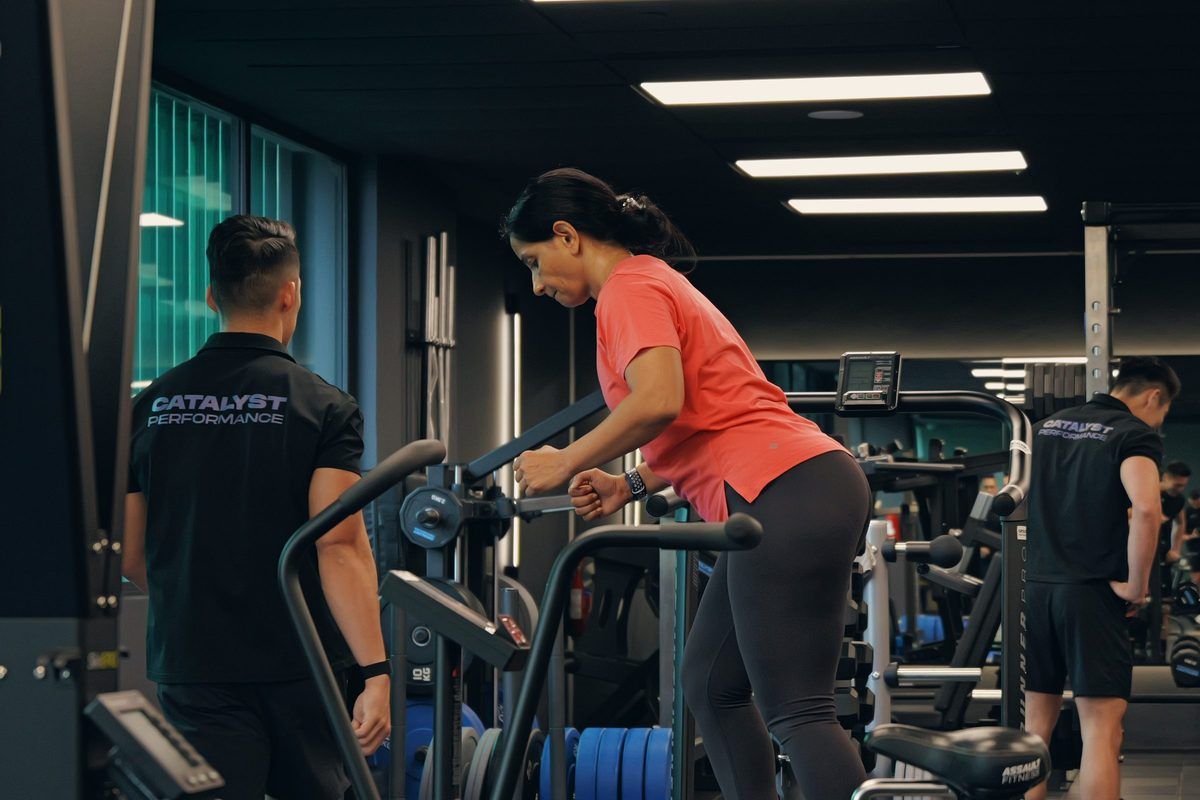 A woman trains on a machine with a Catalyst coach at the studio in Singapore CBD