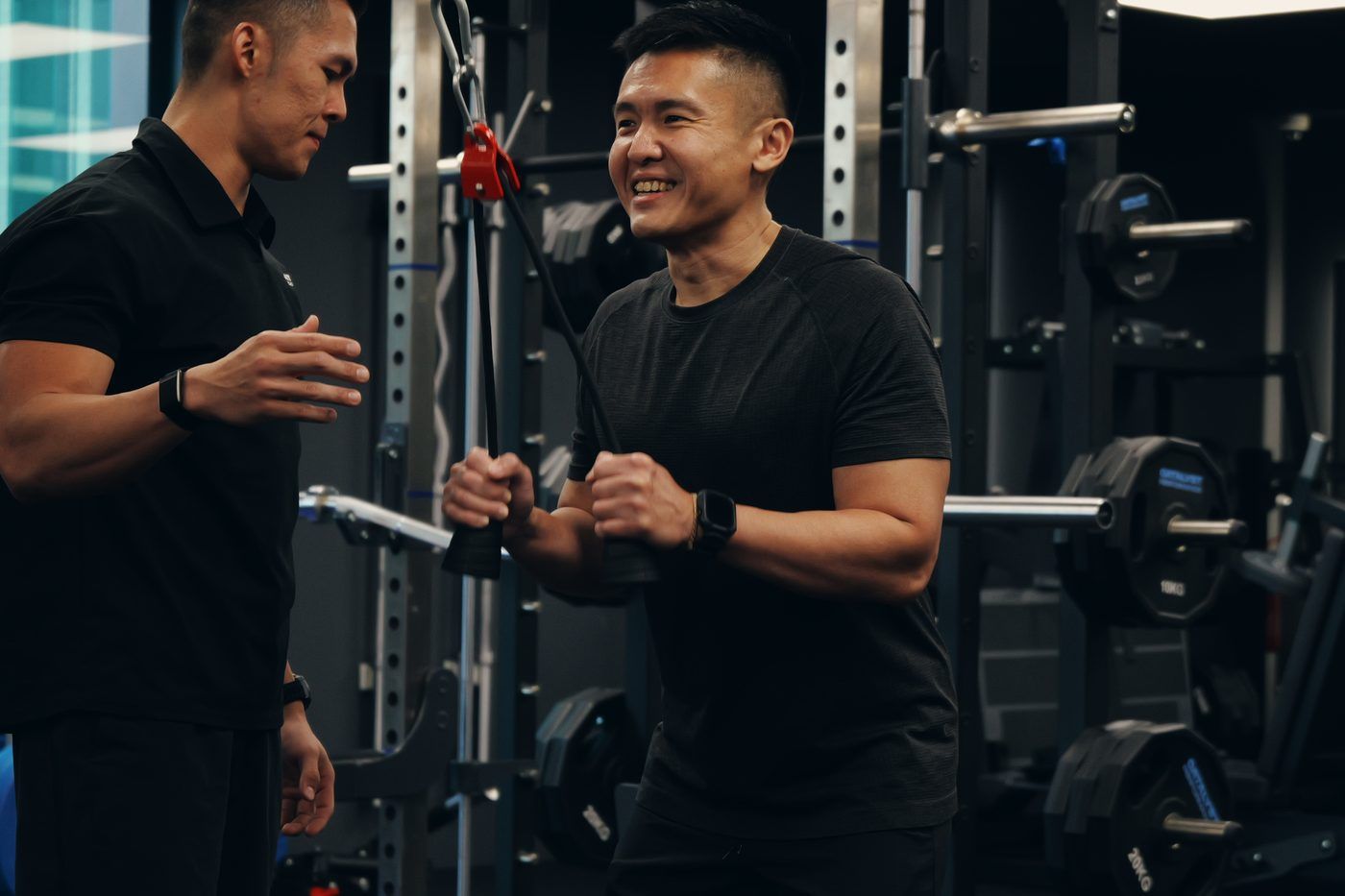 Catalyst Performance coach guiding a client through cable work at the Manulife Tower studio