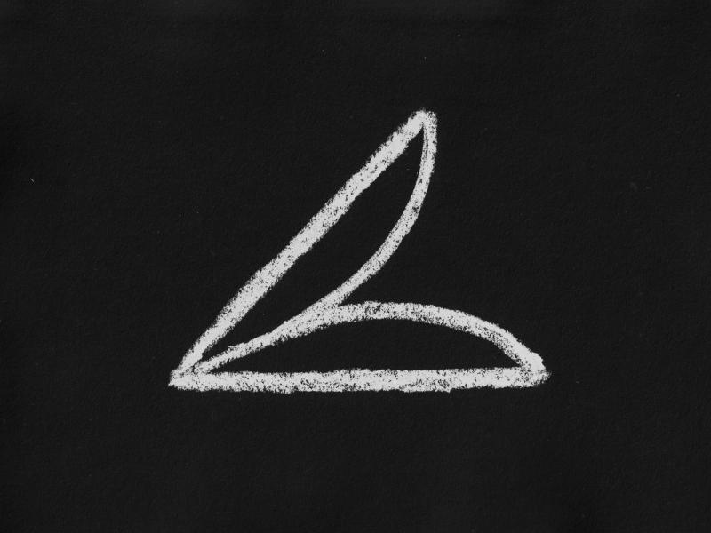 A minimalist chalk drawing on a black surface. The abstract symbol consists of a horizontal base, a diagonal line rising from the right, and a single curved line connecting the two endpoints.
