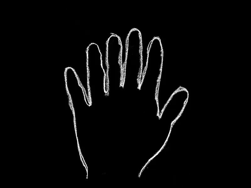 Chalk outline of a human hand with six fingers on a black background, symbolising perception.