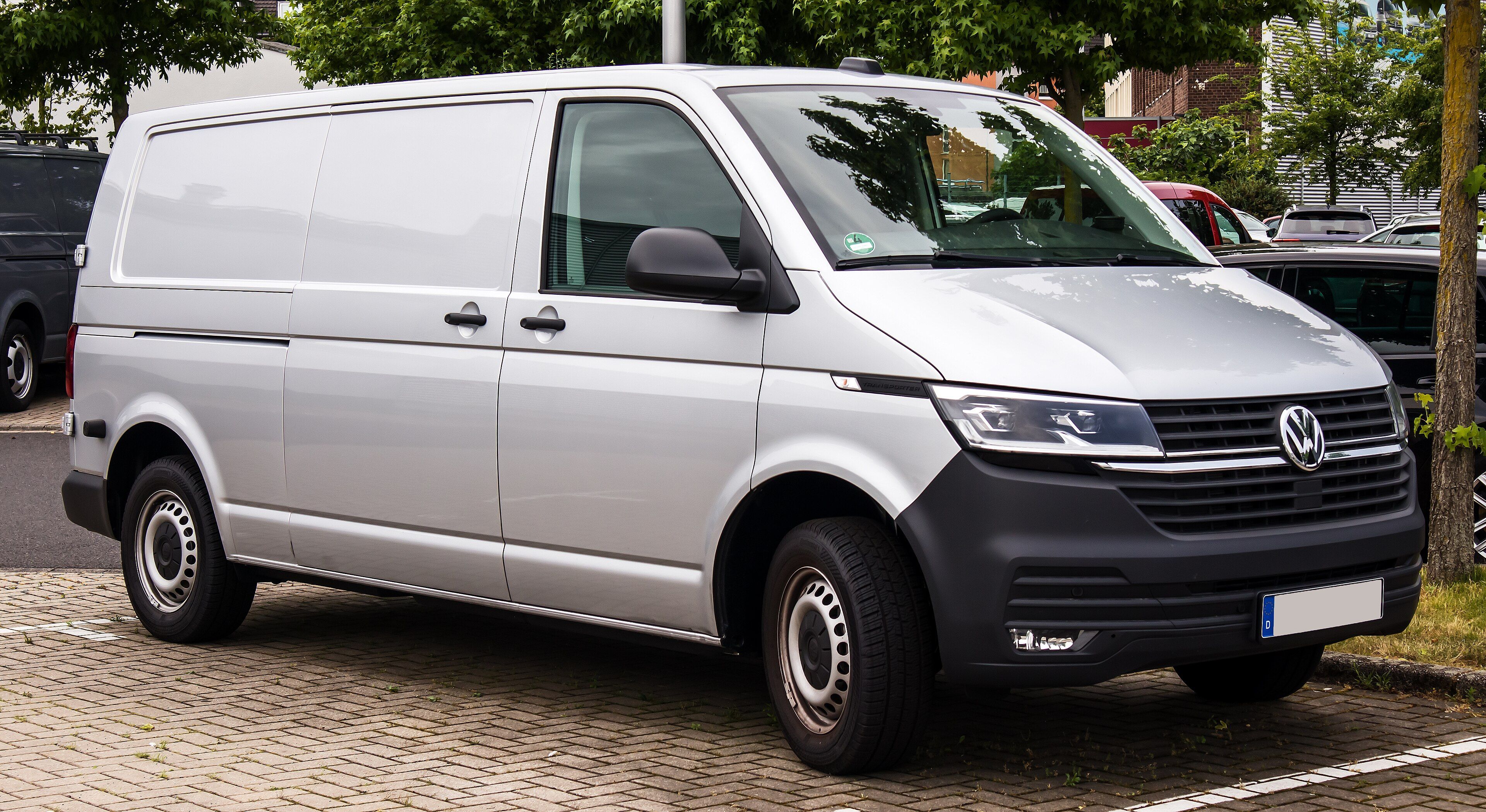 Silver Volkswagen Transporter T6.1 panel van with steel wheels, viewed from the front and passenger side.