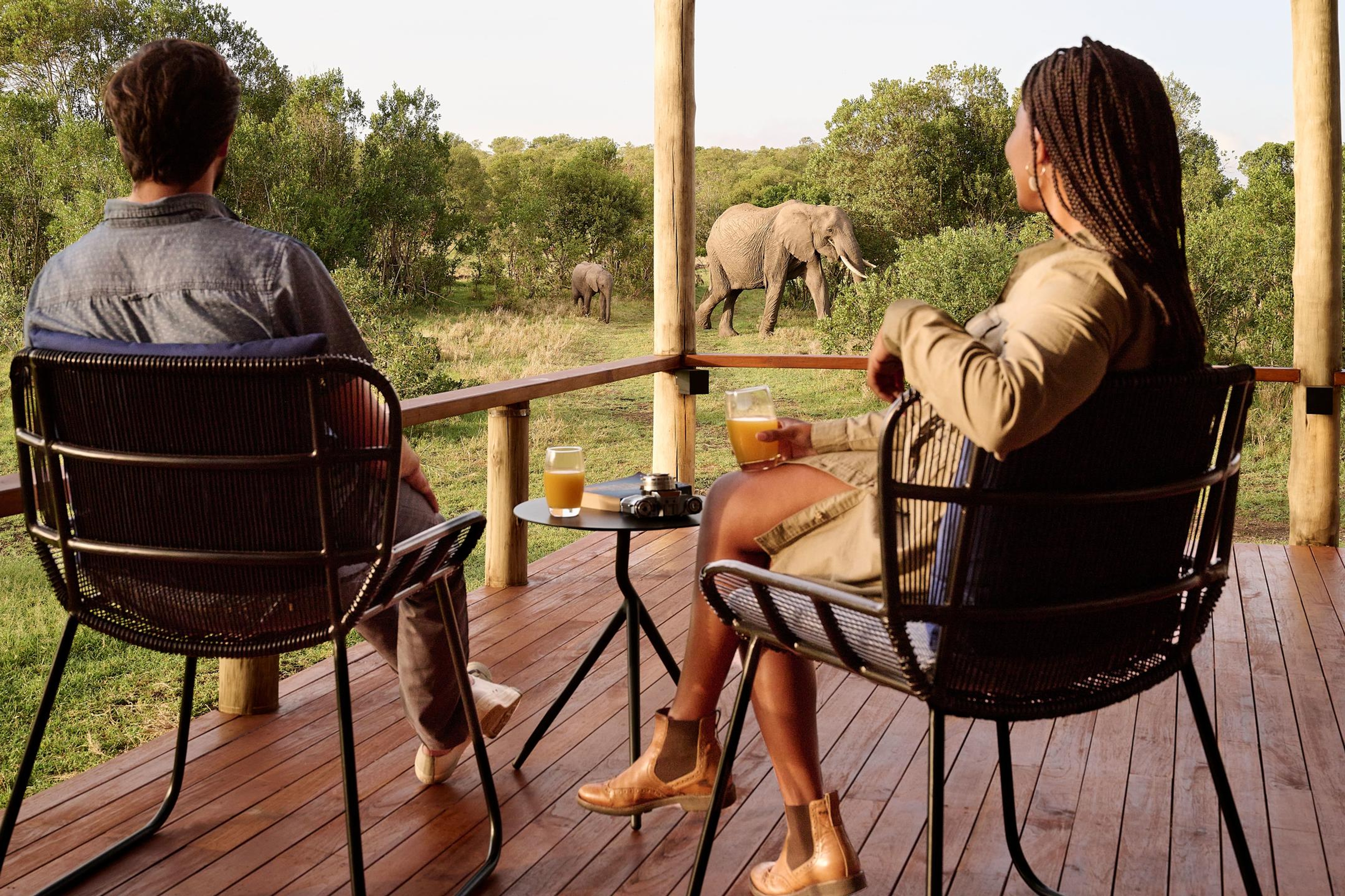 Couple watching elephants from a Kenyan safari lodge
