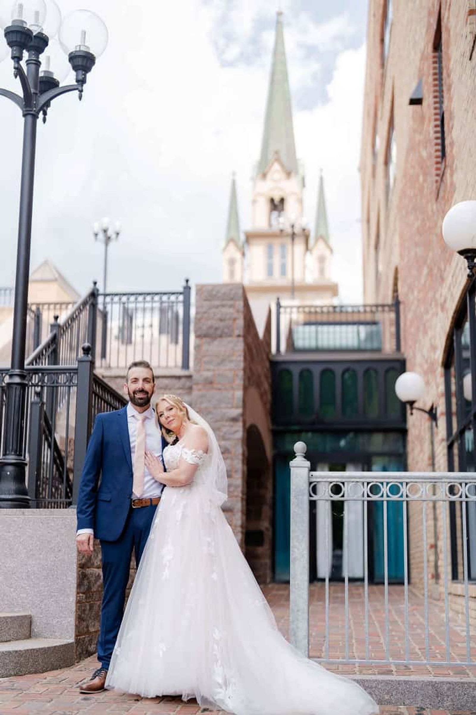 Stone Building Portrait Couple in formal clothing standing outside an ornate stone building.