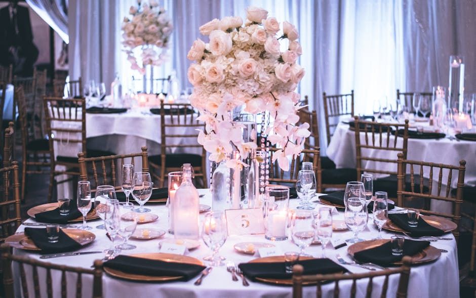Floral Reception Tables Round reception tables with pale floral centerpieces and dark wooden chairs.