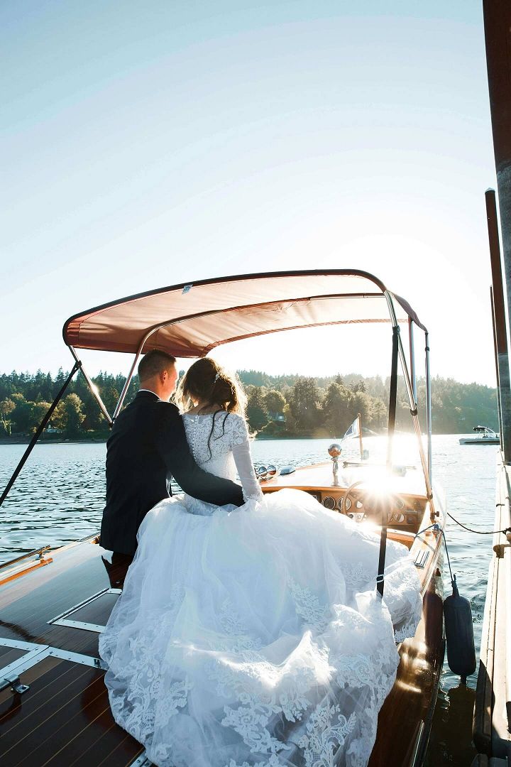 Boat Portrait Person in a white formal dress seated at the back of a small boat.