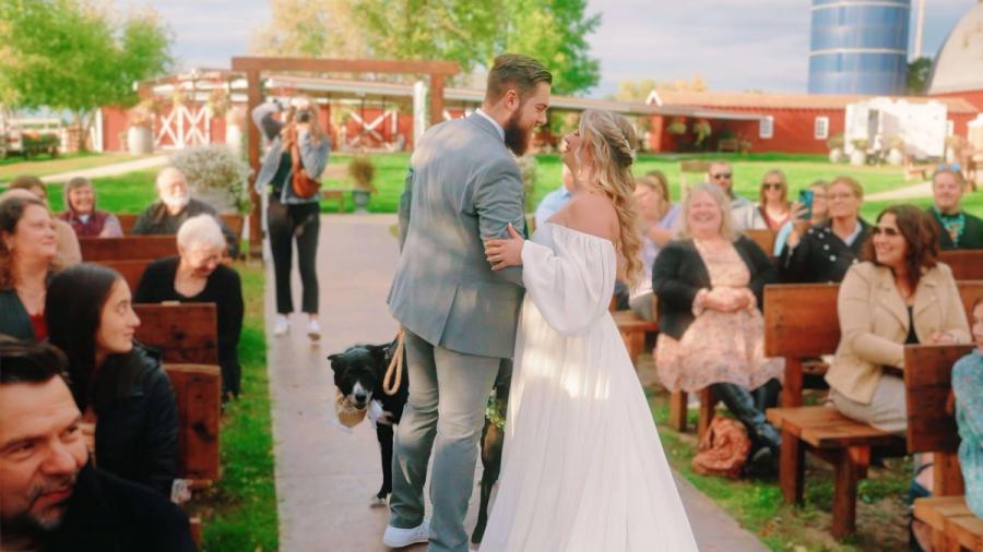 Aisle Kiss Couple in formal clothing kissing in an aisle as seated people watch.