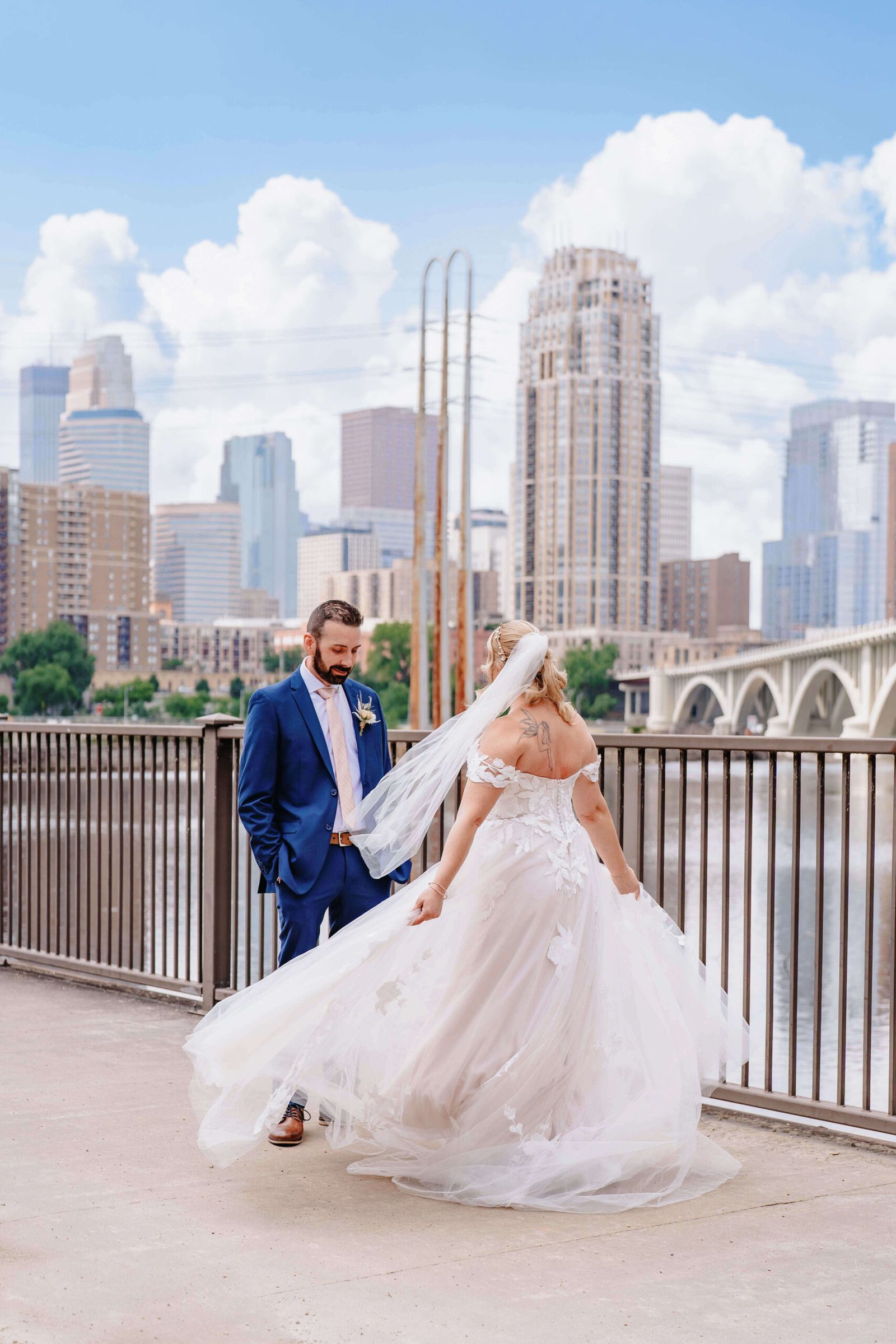 City Bridge Walk Couple in formal clothing walking on a bridge with a city skyline behind.