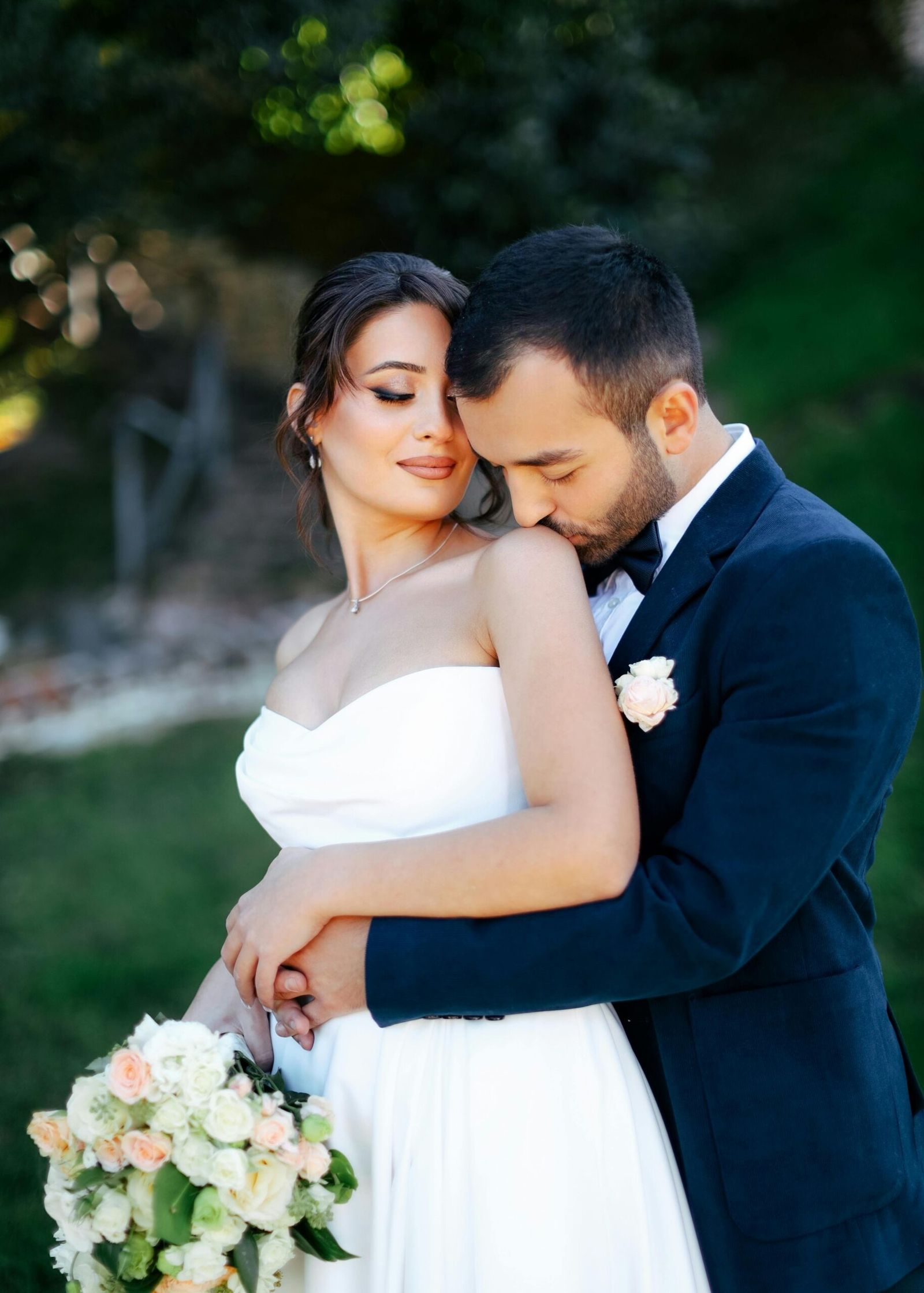 Outdoor Couple Embrace Couple in formal clothing embracing outdoors among trees.