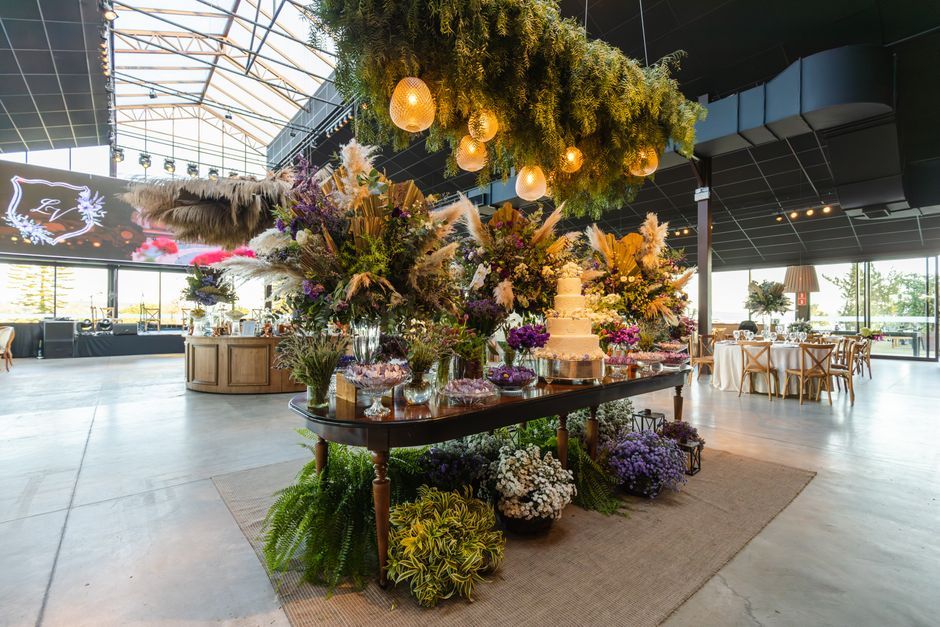 Indoor Floral Display Large indoor floral installation and display table beneath a glass roof.