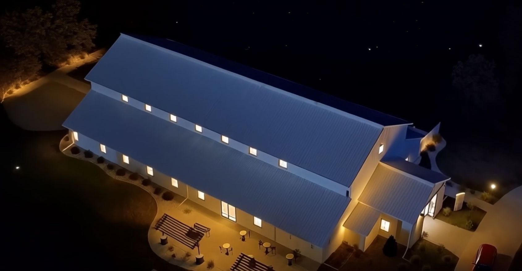 Illuminated Building Aerial nighttime view of a long illuminated building surrounded by darkness.