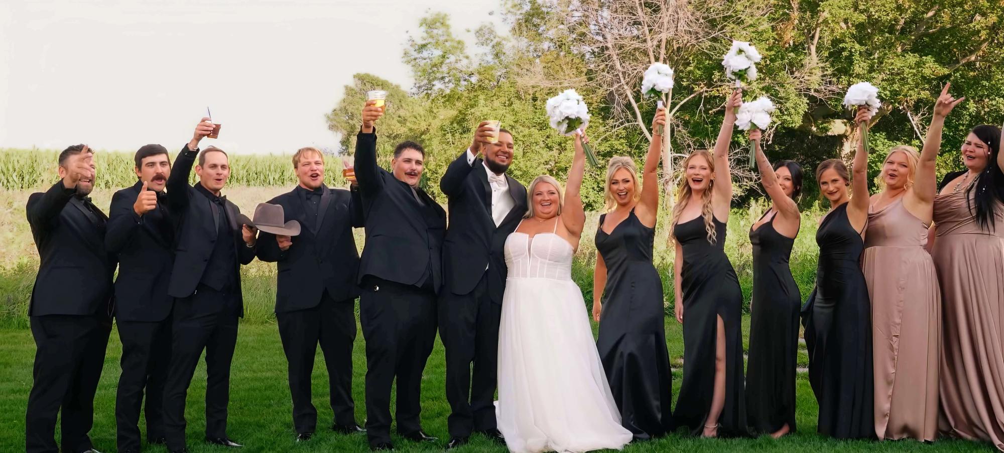 Raised Bouquet Group Formal group outdoors raising bouquets and hands above their heads.