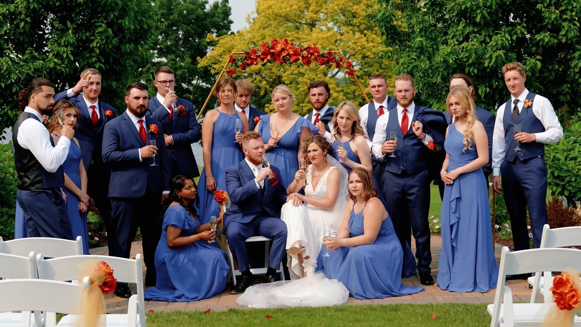 Outdoor Group Portrait Large group in blue, black, and pink formal clothing posed outdoors.