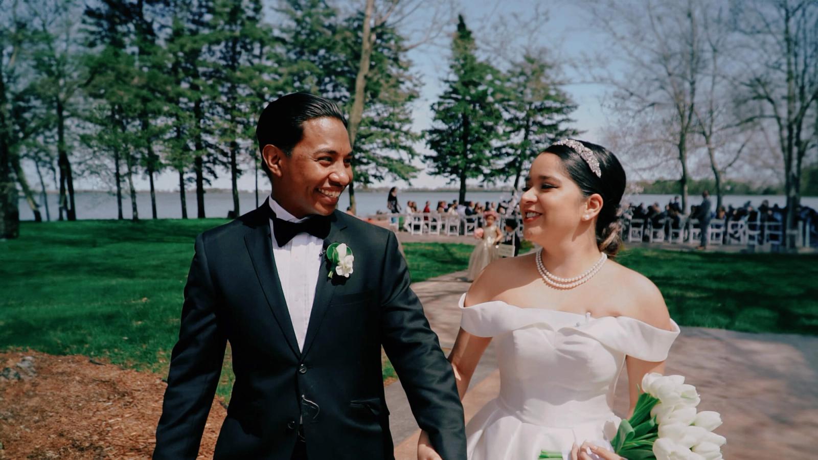Hand in Hand Wedding couple walking hand in hand near trees
