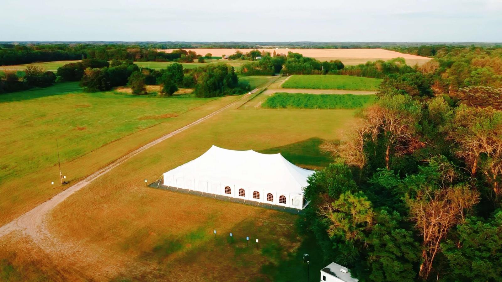 White Event Tent Aerial view of a white event tent in a grassy field