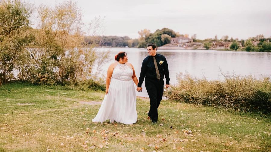Lakeside Walk Wedding couple walking hand in hand beside a lake